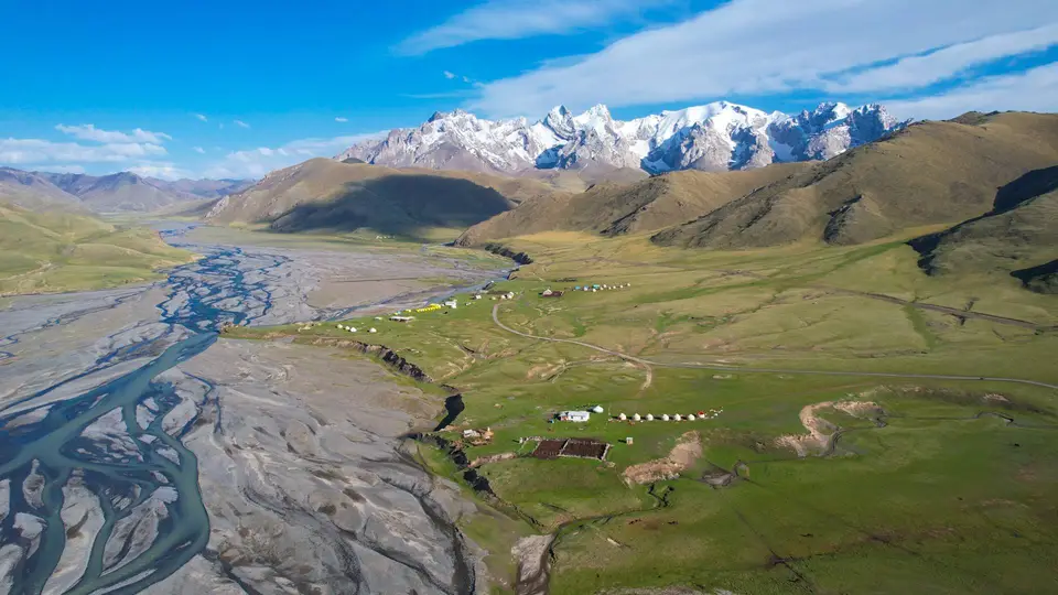 Wide river valley and snow-capped ridges in Kyrgyzstan