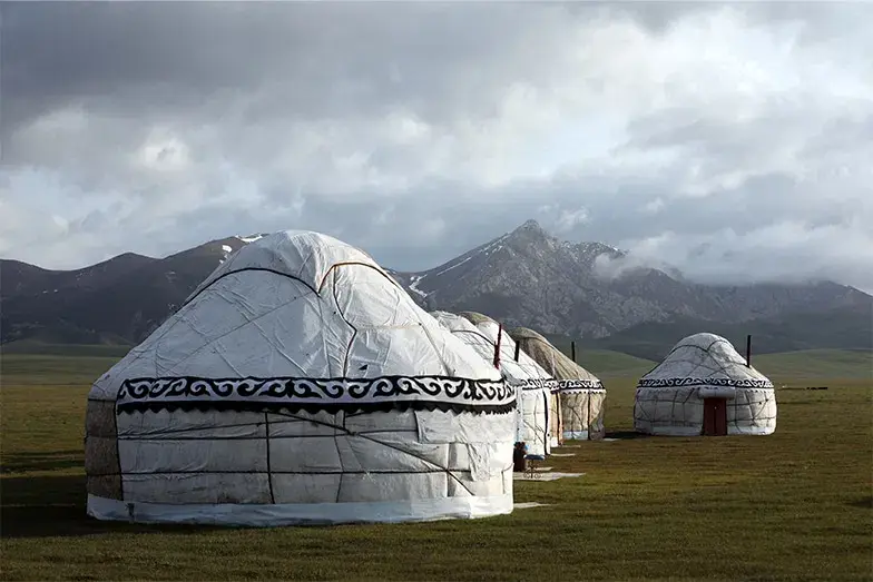 White yurts on a mountain pasture in Kyrgyzstan